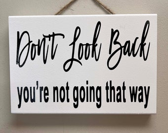 Don't look back You're not going that way sign