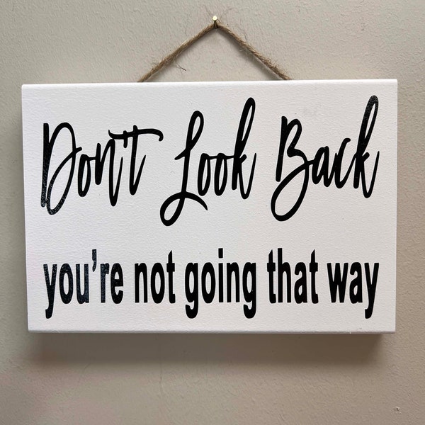 Don't look back You're not going that way sign