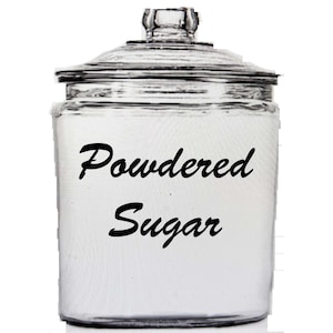 May include: A clear glass jar with a lid, labeled "Powdered Sugar" in black script. The jar is designed for storing dry ingredients. The jar is on a white background.