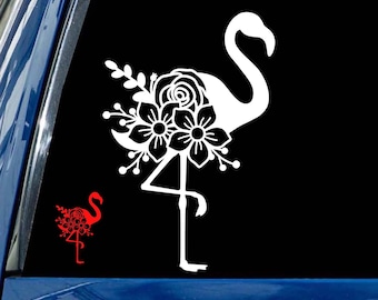 May include: White vinyl decal of a flamingo with flowers on its back. The flamingo is standing on one leg with its neck curved. The decal is on a blue car.