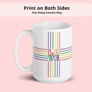 Puede incluir: Taza de cerámica blanca con un diseño de cruz arcoíris y la palabra "LOVE" en el centro. La taza tiene un acabado brillante y un asa grande. El texto en la parte superior dice "Impresión en ambos lados" y "Taza de cerámica brillante de 15 oz".