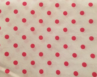 May include: Close-up of a white fabric with a repeating pattern of evenly spaced, bright red polka dots. The dots are circular and appear to be the same size, creating a playful and classic design.