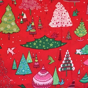 May include: Red fabric with a repeating pattern of stylized Christmas trees in various colors and designs. The trees are decorated with stars, circles, and other geometric shapes.