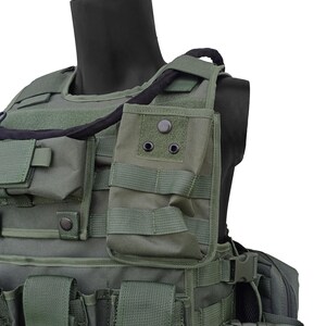 May include: Olive green tactical vest with multiple pouches, straps, and a black neck support. The vest features various compartments and adjustable straps for a secure fit. The design suggests a focus on functionality and durability.
