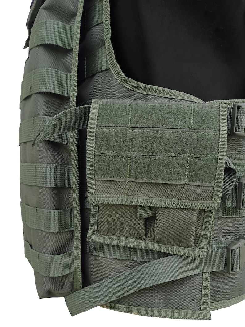 May include: Olive green tactical vest with multiple pouches and MOLLE webbing. The vest features adjustable straps and buckles for a secure fit. The design includes a front pocket with a hook-and-loop closure and additional storage compartments.