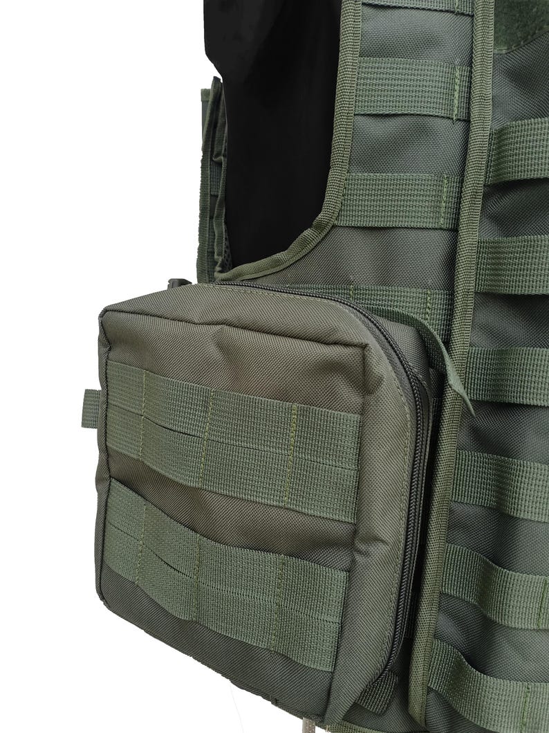 May include: Olive green tactical vest with multiple MOLLE webbing straps and a zippered pouch. The vest features a modular design for attaching additional gear. The image shows a close-up of the vest's details, highlighting its durable construction and functional design.