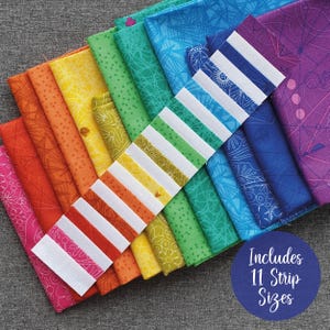 May include: A rainbow assortment of fabric strips in various widths, arranged in a fan shape. The strips are printed with a variety of patterns, including geometric designs, floral motifs, and abstract lines. The text "Includes 11 Strip Sizes" is visible in a blue circle.