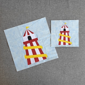 Peut inclure: Deux appliqués en tissu rayés rouge et blanc représentant une tour avec des toboggans jaunes. La plus grande tour est sur un fond bleu et la plus petite sur un fond blanc.