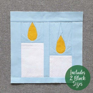 May include: A blue and white quilt block with two yellow candle flames. The block is made up of squares and triangles. The text "Includes 2 Block Sizes" is written in green on a circle.