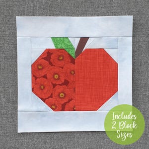 May include: A red and green patchwork apple quilt block with a floral pattern. The block is surrounded by a white border and the text "Includes 2 Block Sizes" is in green on a white circle.