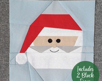 May include: A blue and white patchwork quilt block featuring a Santa Claus face with a red hat. The block includes the text "Includes 2 Block Sizes".