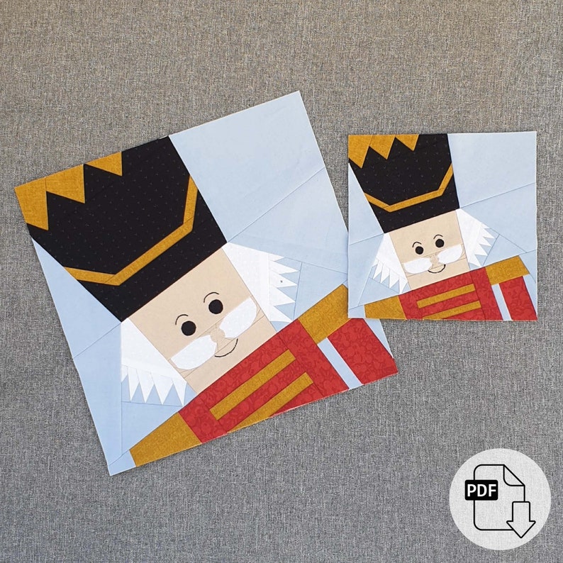 May include: A paper pieced pattern for a Nutcracker doll. The pattern includes two sizes, a larger Nutcracker and a smaller Nutcracker. The pattern is printed on white paper with black lines.
