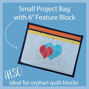 May include: A small project bag with a 6-inch feature block. The bag has a white background with two geometric hearts in red and turquoise. The top has orange and yellow accents with a black border. Text on the bag says "Small Project Bag with 6" Feature Block" and "ALSO ideal for orphan quilt blocks."