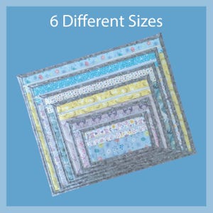 May include: Nested, square fabric placemats in six different sizes. Each placemat features a different patterned fabric, including floral, bunny, and geometric designs. The placemats are bordered with a gray fabric and the text "6 Different Sizes" is at the top.
