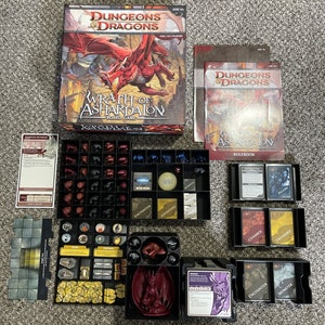 May include: A Dungeons & Dragons board game called Wrath of Ashardalon. The game includes a rulebook, cards, dice, and miniature figures. The box art features a red dragon.