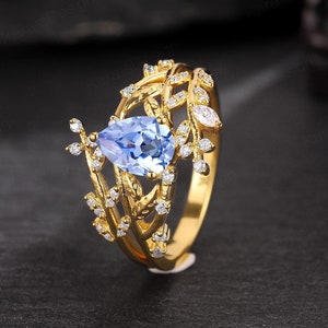 自然にインスパイアされたヤグルマギクのサファイアのつるの婚約指輪アールデコ調 14K ゴールドの枝のプロミスリング ペアシェイプのサファイアの結婚指輪 女性用