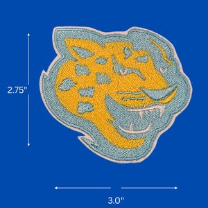 May include: Embroidered patch featuring a jaguar head design. The patch is primarily yellow with blue spots and a blue outline. It measures approximately 2.75 inches high and 3.0 inches wide. The patch is set against a blue background.