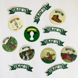 May include: A collection of 13 green and white stickers with the word "Vermont" and various images, including a moose, a house, a cow, and a ice cream cone.