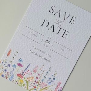 May include: Save the Date card with a watercolor floral design. The card is white with black text that reads "Save the Date", "Saturday", "June 08, 2025", "12PM", and "For the marriage of Chelsea and James".