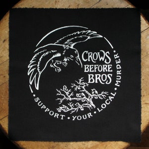 May include: Black patch with a white circle design. The circle features a crow in flight, a tree with birds, and the text "Crows Before Bros. Support Your Local Murder."