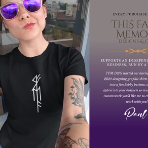 May include: A woman wearing a black t-shirt with a white graphic design of a stylized symbol. The text "EVERY PURCHASE FROM THIS FAINT MEMORY DESIGNS & GIFTS SUPPORTS AN INDEPENDENT SMALL BUSINESS, RUN BY A TEACHER TFM D&G started out during the spring of 2024 designing graphic shirts and has grown into a fun hobby business since then! I appreciate your business so much! If there's any custom work you'd like me to create, I'd love to work with you! Panl" is visible on the right side of the image.