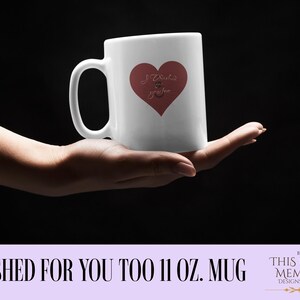 May include: White 11 oz. mug with a red heart design and the words "I wished & you too". The mug is held in a hand against a black background. Text at the bottom reads "I WISHED FOR YOU TOO 11 OZ. MUG".