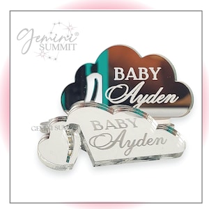 May include: Two silver mirrored acrylic shapes, one a cloud and one a heart, with the text "BABY Ayden" engraved on each.