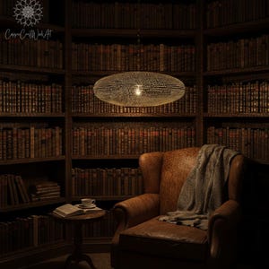 May include: A round, perforated metal pendant light fixture with a warm, glowing interior light, suspended from the ceiling. The lamp features a textured surface with numerous small holes that emit light, creating a soft, diffused illumination.