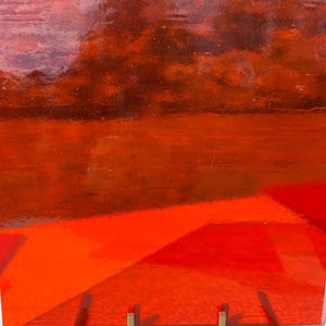 May include: A vibrant, transparent, red-orange glass panel, supported by a brass stand. The glass has a glossy finish and a layered design, with a gradient of colors from dark red to bright orange. The stand has a simple, geometric design.