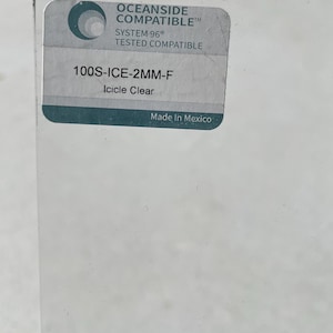 May include: A close-up of a clear glass sheet with a label. The label reads "OCEANSIDE COMPATIBLE", "SYSTEM 96 TESTED COMPATIBLE", "100S-ICE-2MM-F Icicle Clear", and "Made In Mexico".