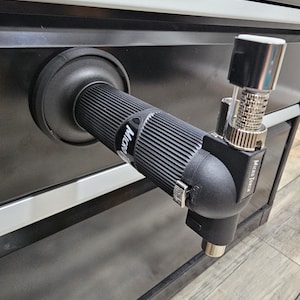 May include: A black Micro Torch with a silver nozzle and a black handle. The torch is attached to a black surface. The text "Micro Torch" is visible on the side of the torch.