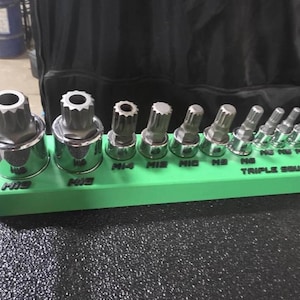 May include: A set of three ceramic mugs with a speckled, matte finish. Each mug features a different color: light blue, cream, and gray. The mugs have a simple, modern design and a comfortable handle.