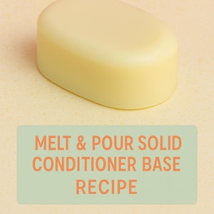 May include: A light yellow, oval-shaped solid conditioner base. The image includes text that reads "Melt & Pour Solid Conditioner Base Recipe" in orange letters on a green rectangle. The background is a light yellow surface with a pink backdrop.