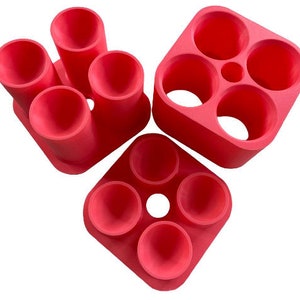 May include: Set of three red silicone molds for making small round candles. The molds are in different sizes and shapes.
