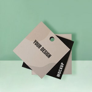 May include: A beige and black tag with a hole for string. The tag has a wavy design and the text "YOUR DESIGN" and "MOCKUP" printed on it.