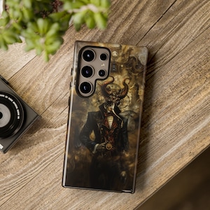 May include: A smartphone case featuring a detailed illustration of a figure with horns, a skull-like face, and a dark suit. The artwork has a steampunk aesthetic with clockwork and gears. The case is on a wooden surface.