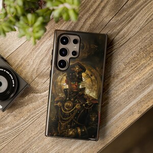 May include: A smartphone case with a steampunk design. The case shows a detailed illustration of a man in a military uniform with a clock face background. The colour palette includes gold, black, and brown tones.