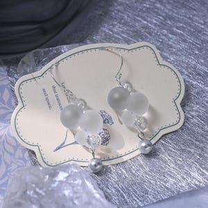 Bubble Earrings, Glass Bead Earrings, Silver Jewelry, Cloud-Inspired Earrings, Frosted Bead Earrings, Transparent Dewdrop Earrings, Celestial Accessories, Ethereal Fashion, Pearl Beaded Earrings, Handmade Statement Jewelry, Unique Aesthetic Earrings, Floating Bubble Design, Modern Minimalist Earrings, Lightweight Dangle Earrings, Dreamy Fashion Accessories, Silver-Toned Jewelry, Elegant Glass Earrings, Cloud-Like Floating Earrings, Artistic Handmade Jewelry