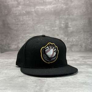 May include: Black baseball cap with a flat brim. The cap features an embroidered baseball design in white, red, and black, outlined in yellow. The cap is made of a felt-like material.
