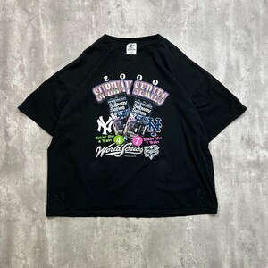 May include: Black t-shirt with a graphic design celebrating the 2000 Subway Series. The design includes the text "2000 Subway Series" and logos for the New York Yankees and New York Mets. The shirt also has the text "World Series".