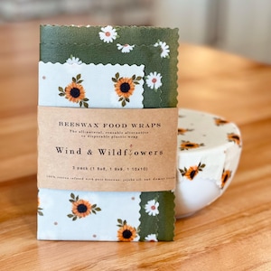 May include: A white ceramic mug with a black handle and the text "But First, Coffee" in a handwritten style. The mug is on a white surface. The mug is 4 inches tall.