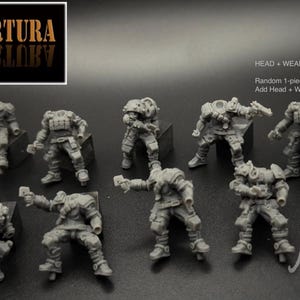 May include: A collection of unpainted miniature figures in various combat poses. The figures are gray and detailed, with tactical gear. Text in the image reads "EN COBERTURA" and "Mojo Amok miniatures."