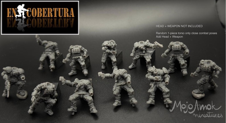 May include: A collection of unpainted miniature figures in various combat poses. The figures are gray and detailed, with tactical gear. Text in the image reads "EN COBERTURA" and "Mojo Amok miniatures."