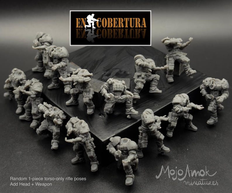 May include: A collection of gray miniature figures in various action poses, likely for tabletop gaming. The figures are detailed with armor and weaponry. The image includes text that reads "EN COBERTURA" and "Mojo Amok miniatures."