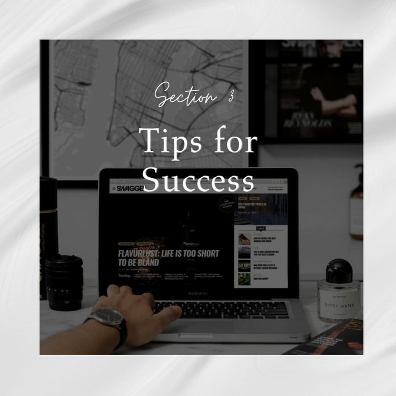 May include: A laptop computer with a website open on the screen. The website has the text "FLAVURLUST: LIFE IS TOO SHORT TO BE BLAND" on the screen. The laptop is on a desk with a black and white photo, a black camera lens, and a bottle of perfume.