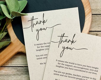 May include: Two thank you cards with a handwritten message on a brown background. The text reads "Thank you" and "It means the world to have you here tonight for the support, encouragement, love and laughter you have contributed to our lives. You are our guides, teachers, partner in this union and our favorite people in the world. We hope you enjoy tonight's celebration. Love, Emma + Ryan."