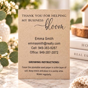 May include: A rectangular tan card with black text reading: THANK YOU FOR HELPING MY BUSINESS bloom, Emma Smith, emmasmith@realty.com, Cell: 949-383-9287, Office: 949-287-2872, GROWING INSTRUCTIONS: Cover the plantable seed paper in a thin layer of soil.