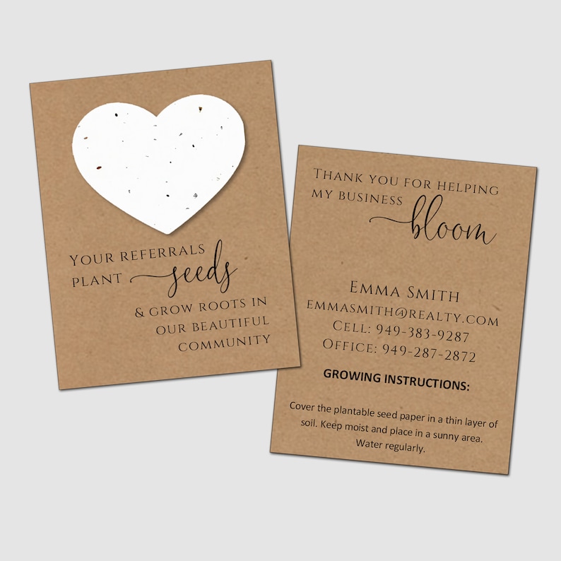 May include: Two rectangular brown kraft paper cards with black text. One card features a white heart-shaped piece of plantable seed paper and the text: YOUR REFERRALS PLANT seeds & GROW ROOTS IN OUR BEAUTIFUL COMMUNITY. The other card reads: THANK YOU FOR HELPING MY BUSINESS bloom, EMMA SMITH, EMMA SMITH@REALTY.COM, CELL: 949-383-9287, OFFICE: 949-287-2872, GROWING INSTRUCTIONS: Cover the plantable seed paper in a thin layer of soil. Keep moist and place in a sunny area. Water regularly.