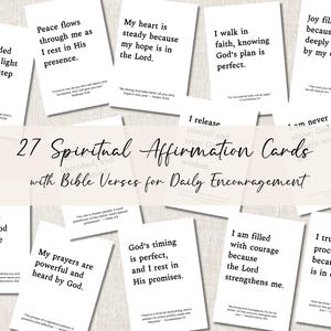 May include: A collection of 27 spiritual affirmation cards with Bible verses for daily encouragement. Each white card features a different inspirational quote in black text. The cards are arranged on a light-colored surface.