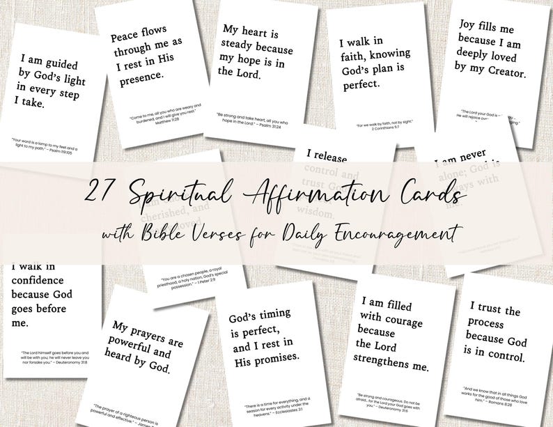 May include: A collection of 27 spiritual affirmation cards with Bible verses for daily encouragement. Each white card features a different inspirational quote in black text. The cards are arranged on a light-colored surface.